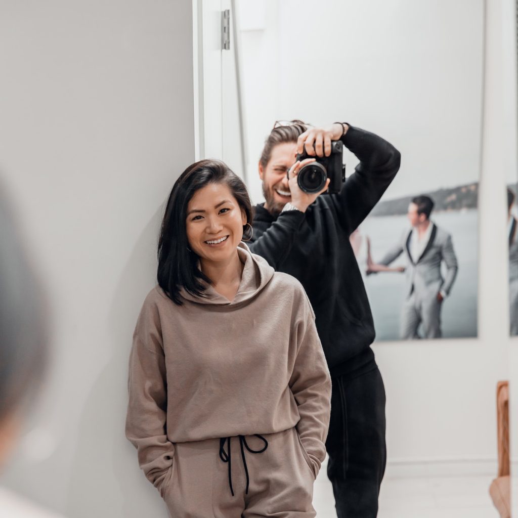 woman in brown sweater standing and smiling